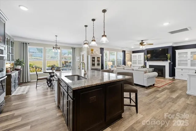 a kitchen with stainless steel appliances granite countertop a sink a stove and a refrigerator