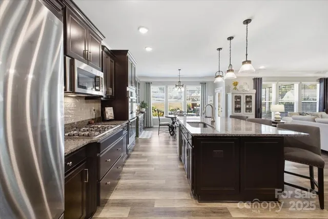 a living room with furniture and kitchen view