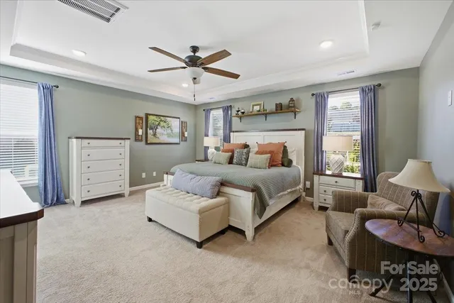 a bedroom with furniture and a large window