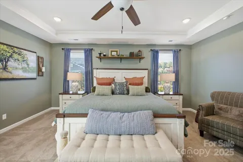 a bedroom with a bed and a ceiling fan
