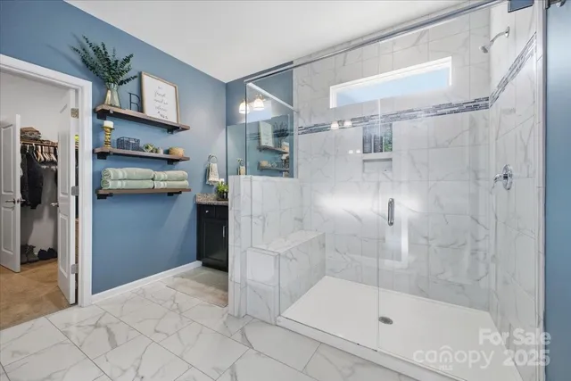a large en suite bathroom with a granite countertop sink mirror and toilet