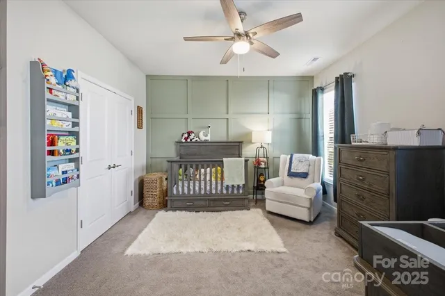 a bedroom with furniture and a baby crib