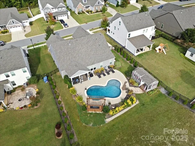 an aerial view of a house with table and chairs
