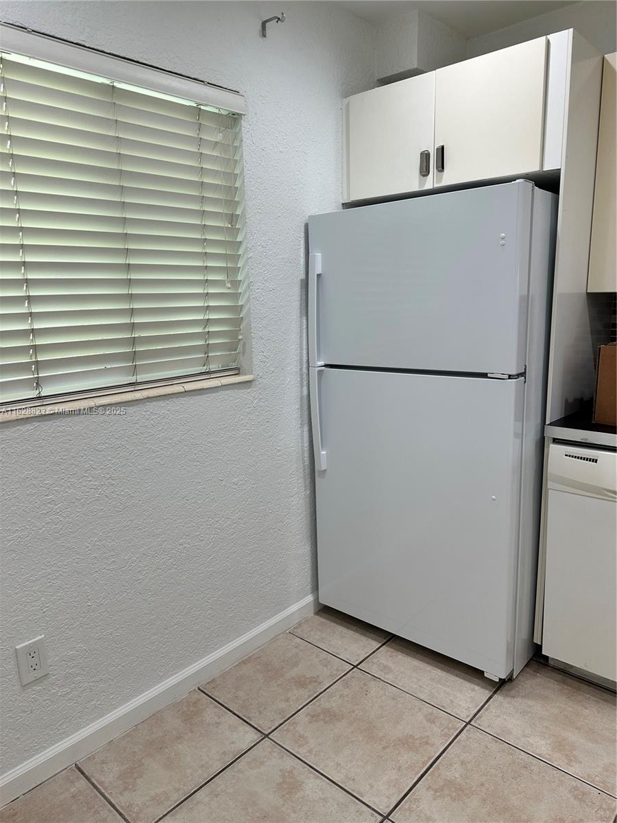 8600 Southwest 67th Avenue, Unit 908 Pinecrest, FL 33156 - Photo 18 of 25 a white refrigerator freezer and a refrigerator in a kitchen