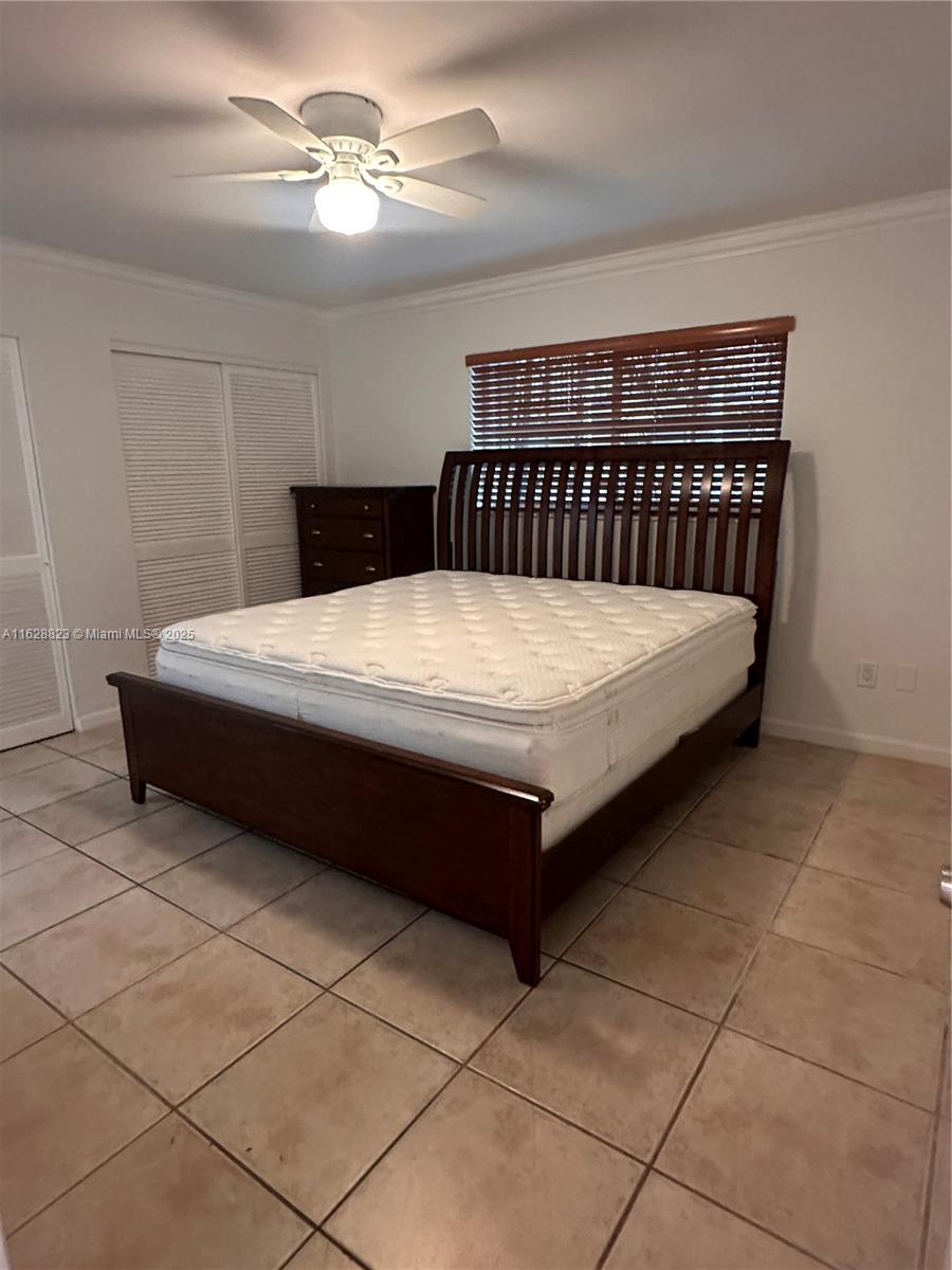 8600 Southwest 67th Avenue, Unit 908 Pinecrest, FL 33156 - Photo 23 of 25 a bedroom with a bed and a chandelier