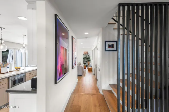 a view of a hallway with paintings on the wall