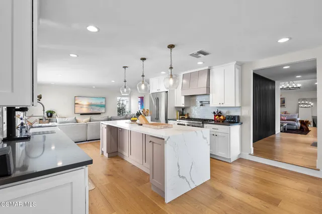 a kitchen with cabinets a sink and appliances
