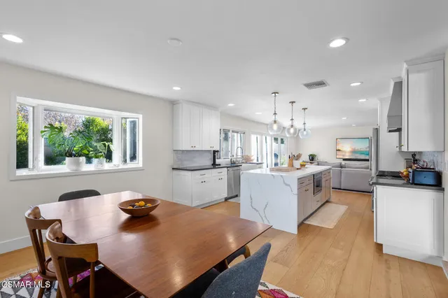 a kitchen with sink cabinets and wooden floor