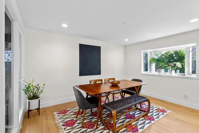 a dining room with furniture and wooden floor
