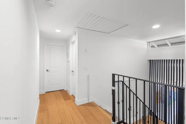 a view of hallway with wooden floor