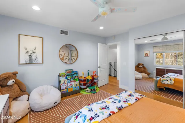 a bed room with furniture and a baby crib