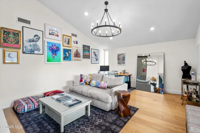 a living room with furniture and view of kitchen