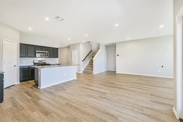 a view of kitchen with microwave and cabinets