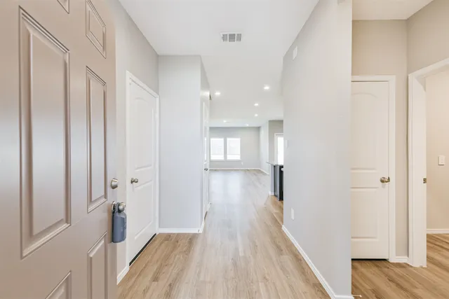 a view of hallway with wooden floor