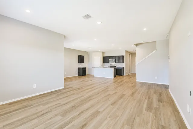 a view of a kitchen with a sink and a refrigerator