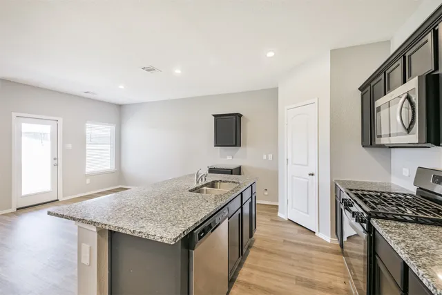 a kitchen with a stove and a sink