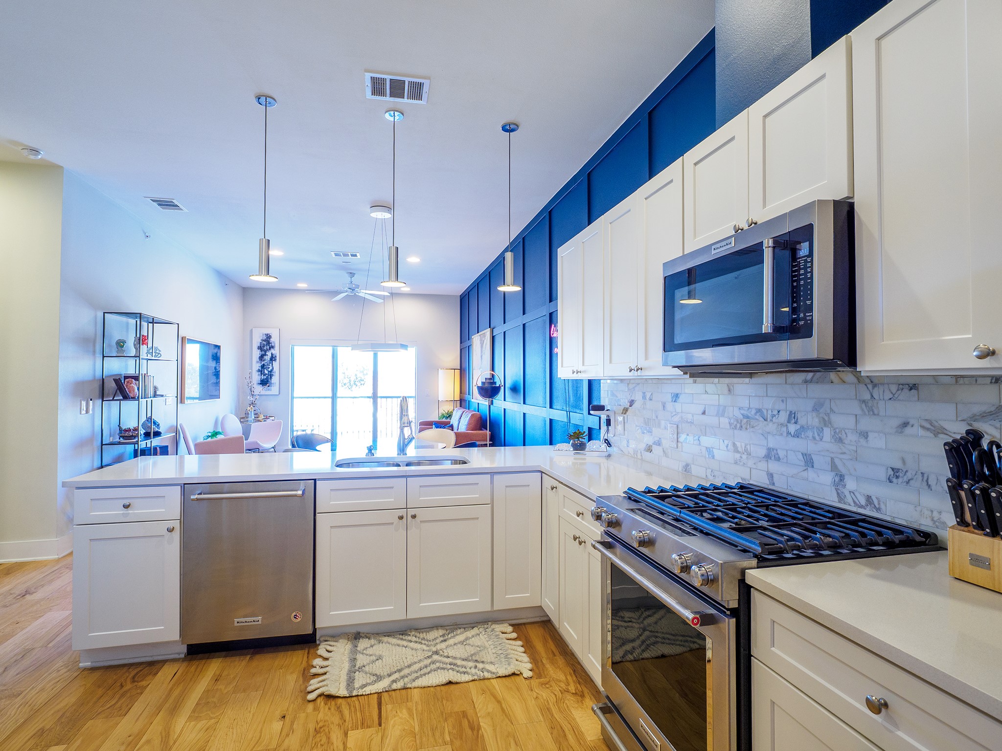 908 Nueces Street, Unit 44 Austin, TX 78701 - Photo 29 of 29 Kitchen featuring appliances with stainless steel finishes, open floor plan, white cabinets, decorative light fixtures, and recessed lighting