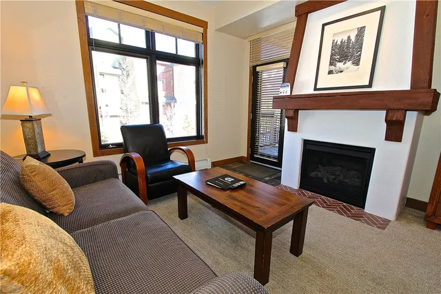 a living room with furniture a window and a fireplace