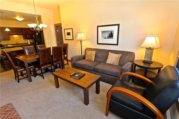 a living room with furniture and a lamp