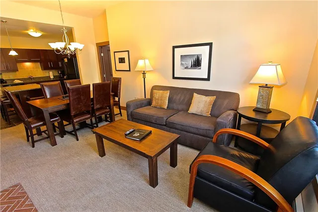 a living room with furniture and a lamp