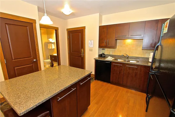 a kitchen with a sink stove and refrigerator