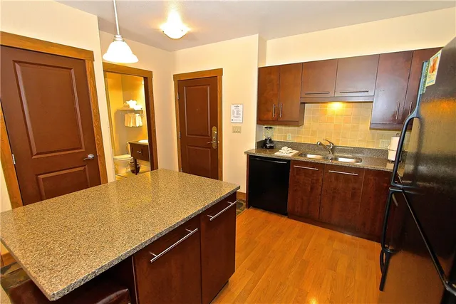 a kitchen with a sink stove and refrigerator