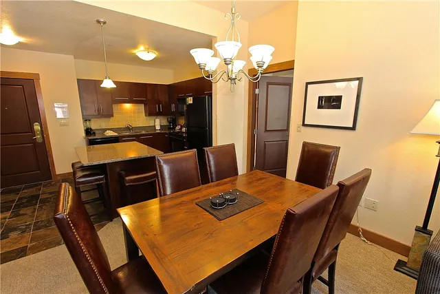 a view of a dining room with furniture and a chandelier