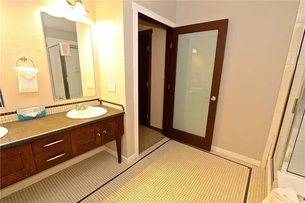 a bathroom with a double vanity sink and mirror
