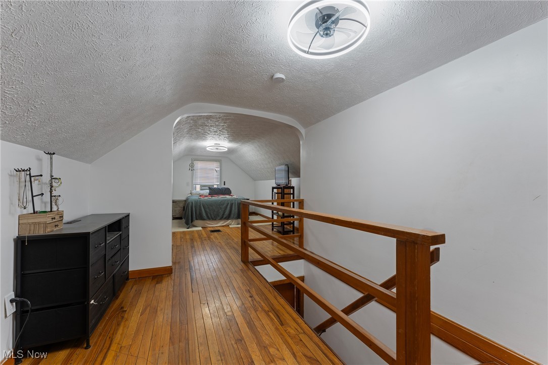123 North Seneca Street Rittman, OH 44270 - Photo 18 of 32 Bedroom featuring lofted ceiling, baseboards, a textured ceiling, and wood-type flooring