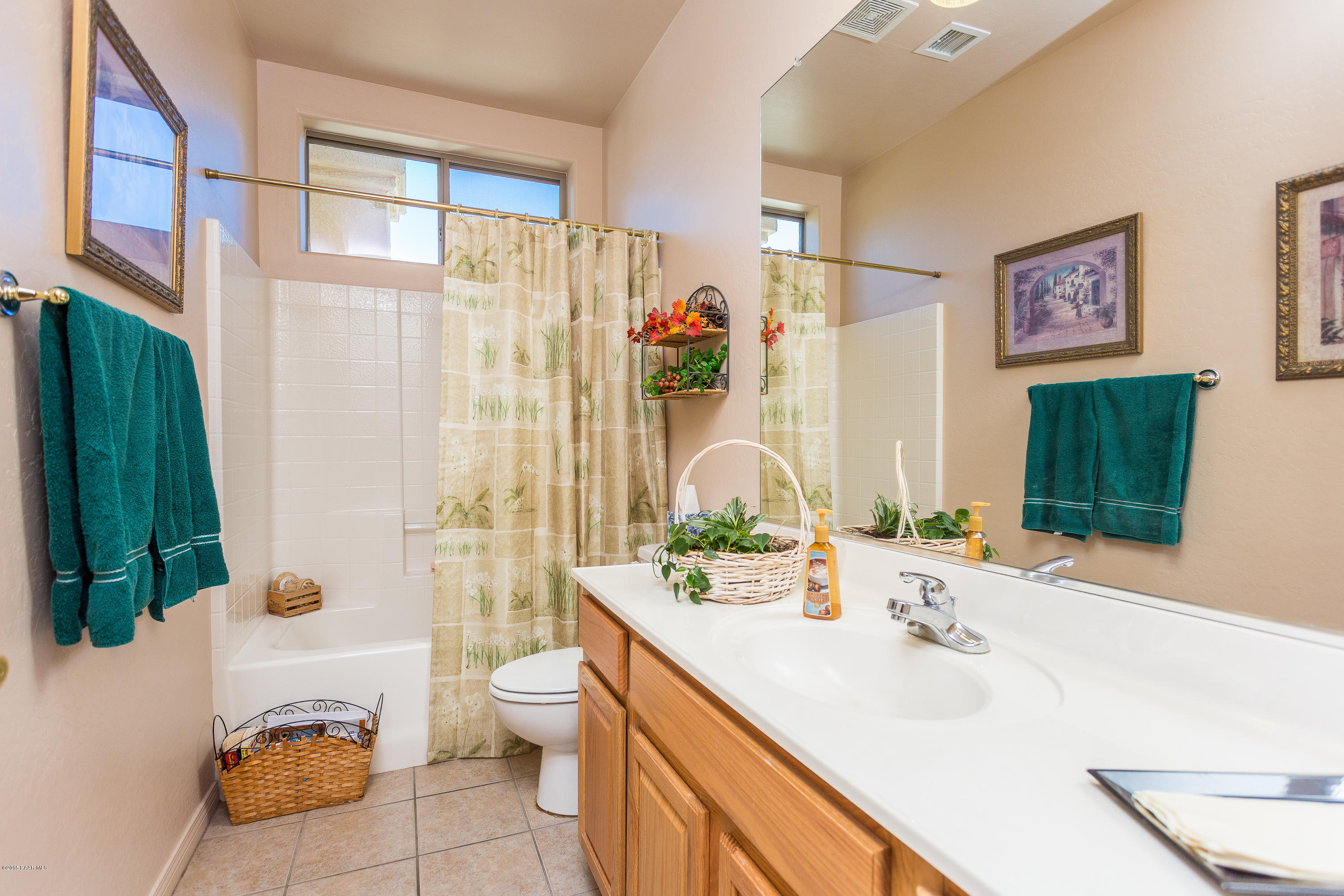 7861 North Rambling Lane Prescott Valley, AZ 86315 - Photo 11 of 15 a bathroom with a double vanity sink toilet and shower