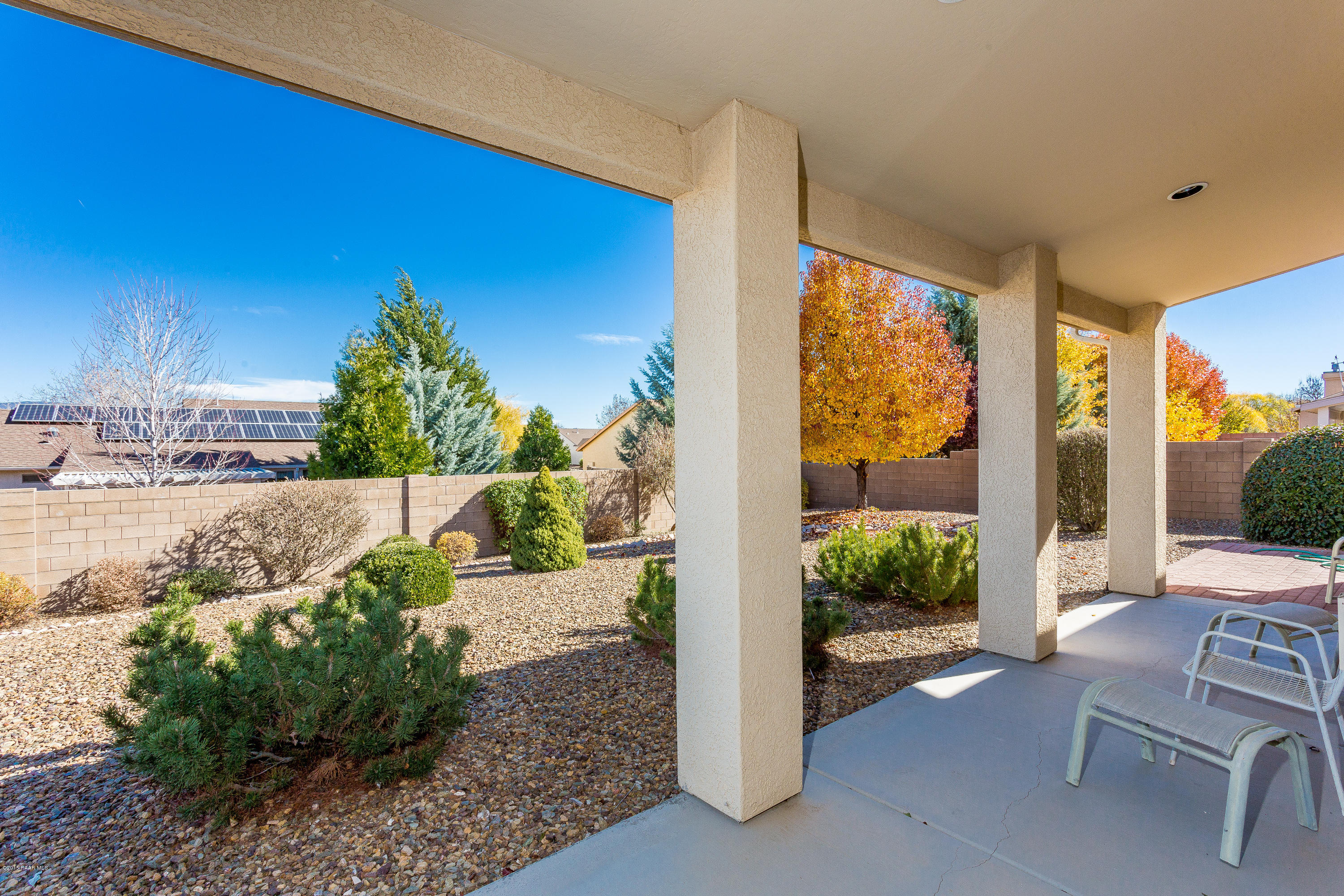 7861 North Rambling Lane Prescott Valley, AZ 86315 - Photo 14 of 15 a view of a patio with table and chairs potted plants with wooden fence