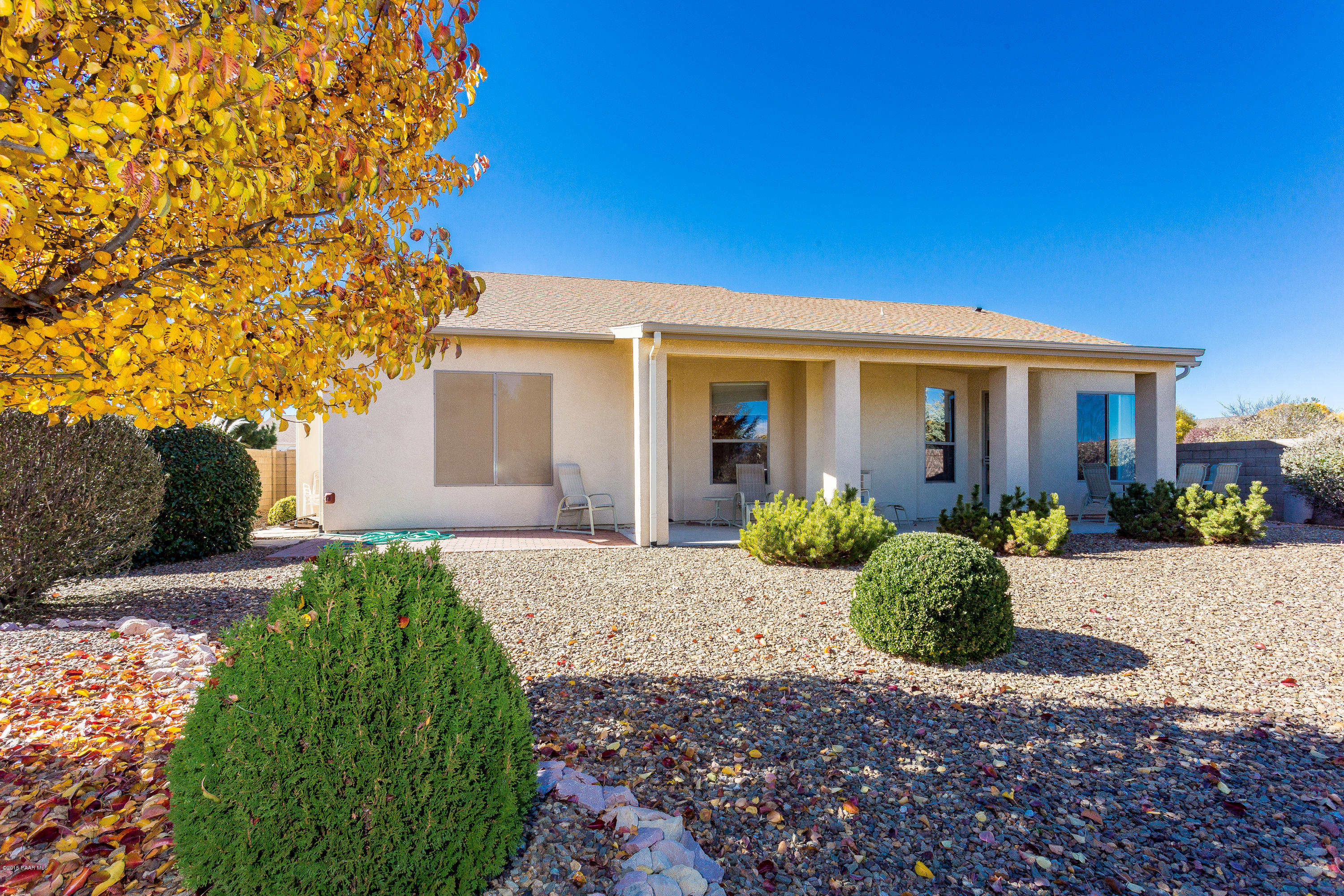 7861 North Rambling Lane Prescott Valley, AZ 86315 - Photo 15 of 15 a front view of a house with a yard and potted plants