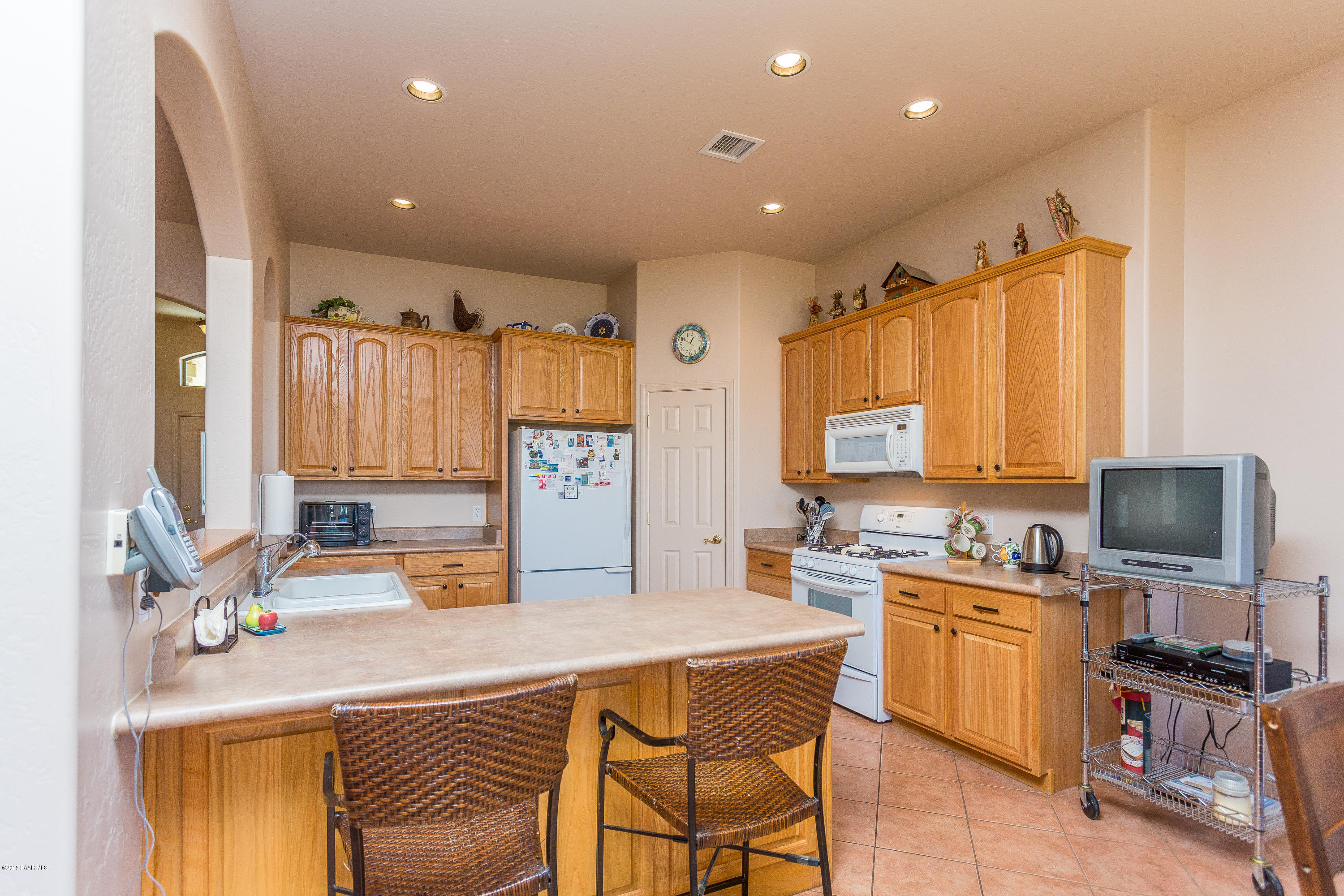 7861 North Rambling Lane Prescott Valley, AZ 86315 - Photo 5 of 15 a kitchen with a sink stove and refrigerator