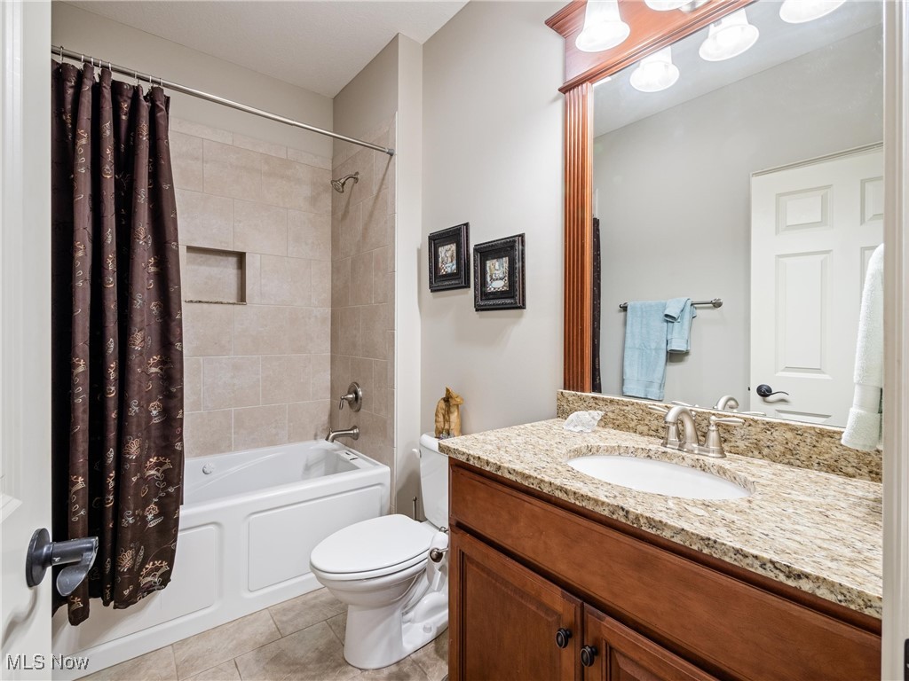 5349 Slater Ridge Westerville, OH 43082 - Photo 7 of 50 Bathroom featuring shower / bathtub combination with curtain, vanity, and light tile patterned floors