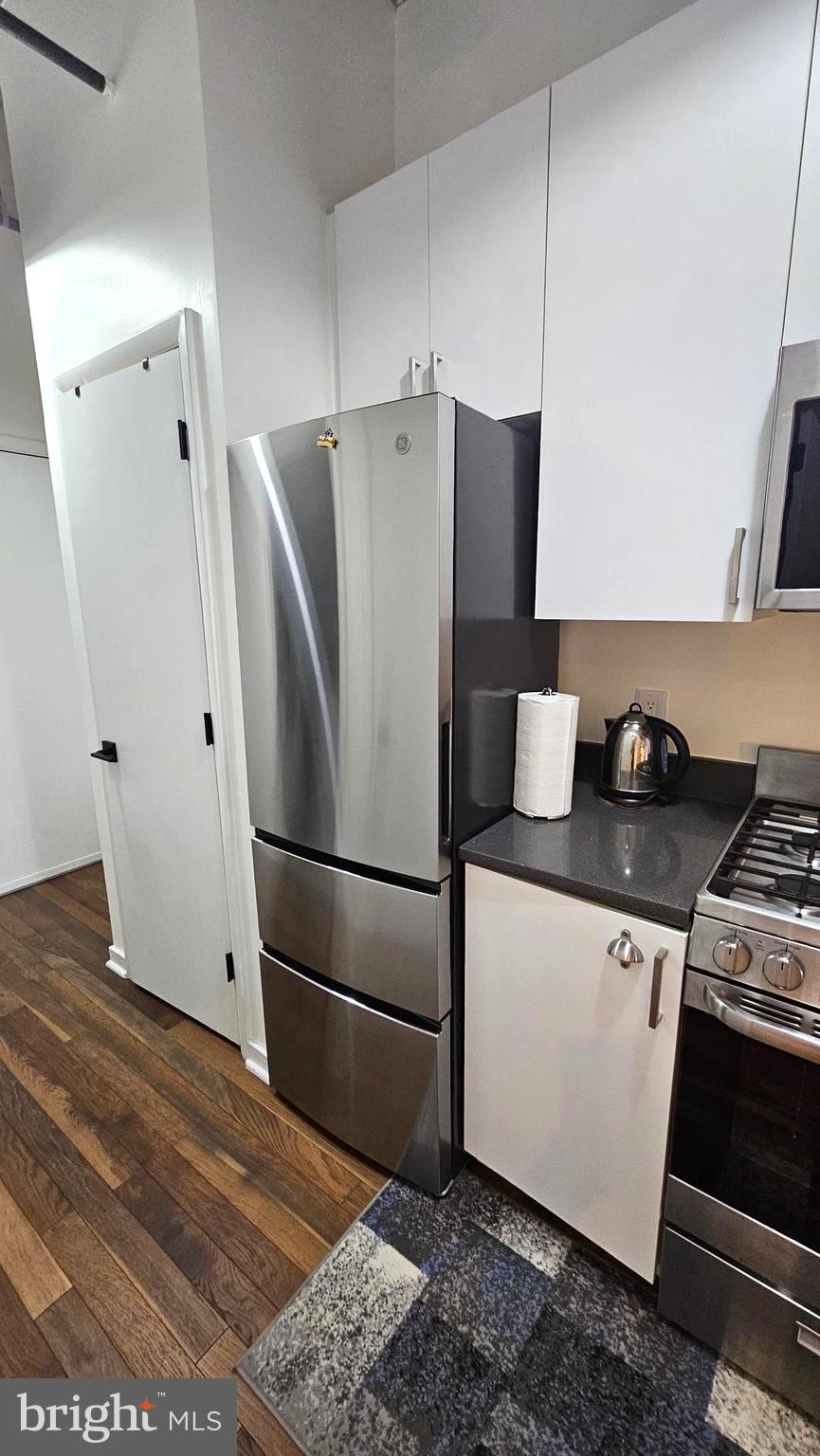 1300 N Street Northwest, Unit 713 Washington, DC 20005 - Photo 13 of 33 a white refrigerator freezer sitting in a kitchen