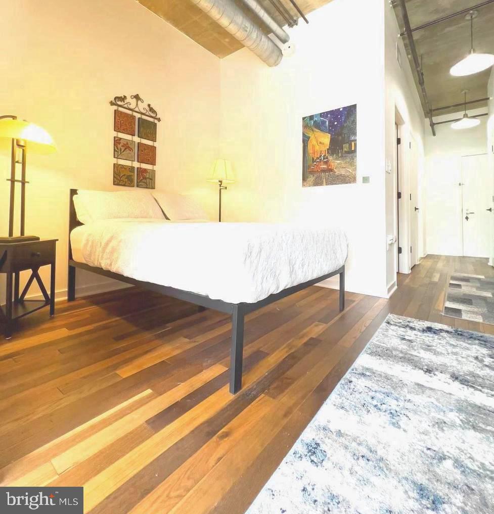 1300 N Street Northwest, Unit 713 Washington, DC 20005 - Photo 19 of 38 a bedroom with a bed and a table