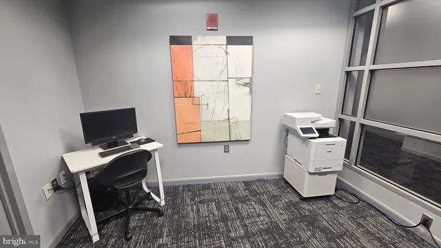 a workspace with furniture and window