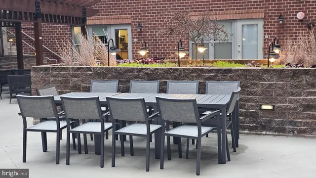 a view of a patio with table and chairs and potted plants