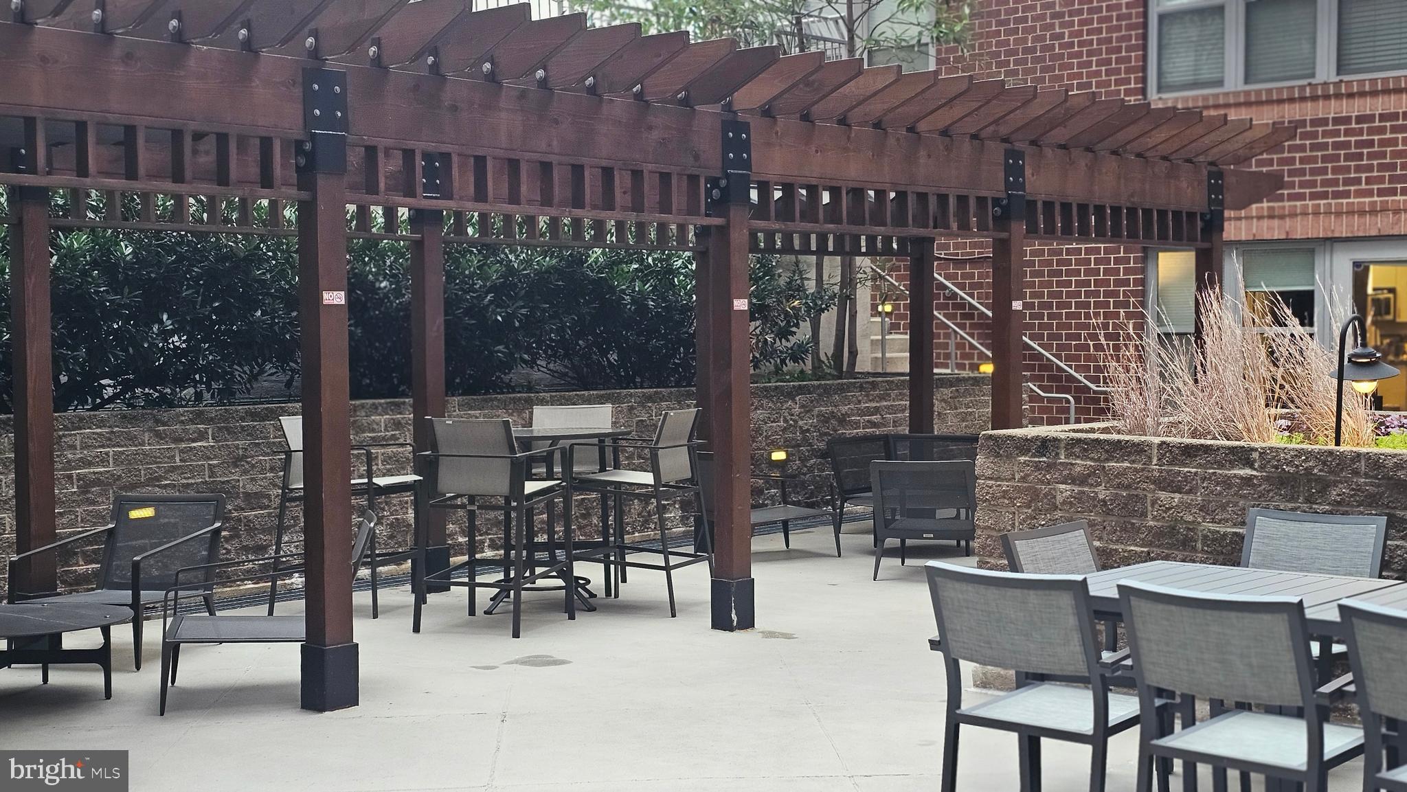 1300 N Street Northwest, Unit 713 Washington, DC 20005 - Photo 24 of 33 a view of a patio with table and chairs and potted plants