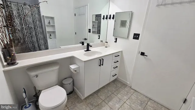 a bathroom with a sink a toilet and mirror