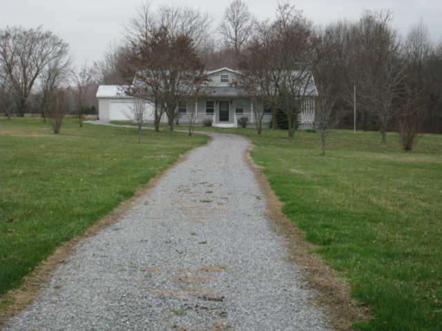 7004 Williams Road Cross Plains, TN 37049 - Photo 1 of 18 a front view of house with yard and green space