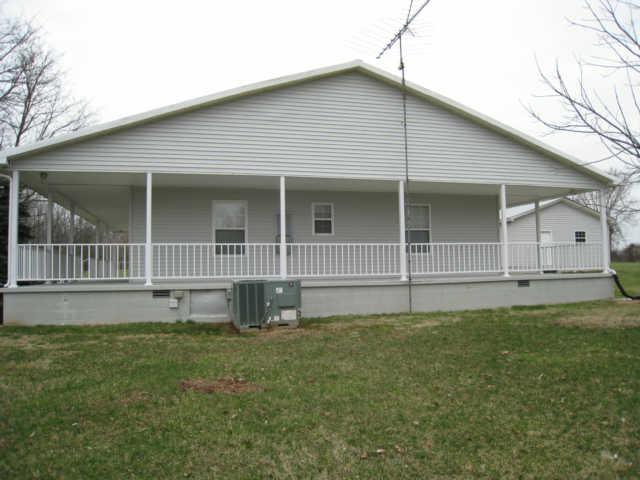 7004 Williams Road Cross Plains, TN 37049 - Photo 6 of 18 a front view of a house with a garden