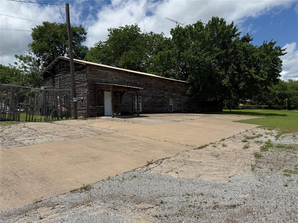 a view of wooden fence and trees around