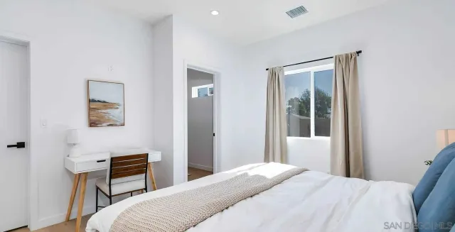 a bedroom with a bed and a window