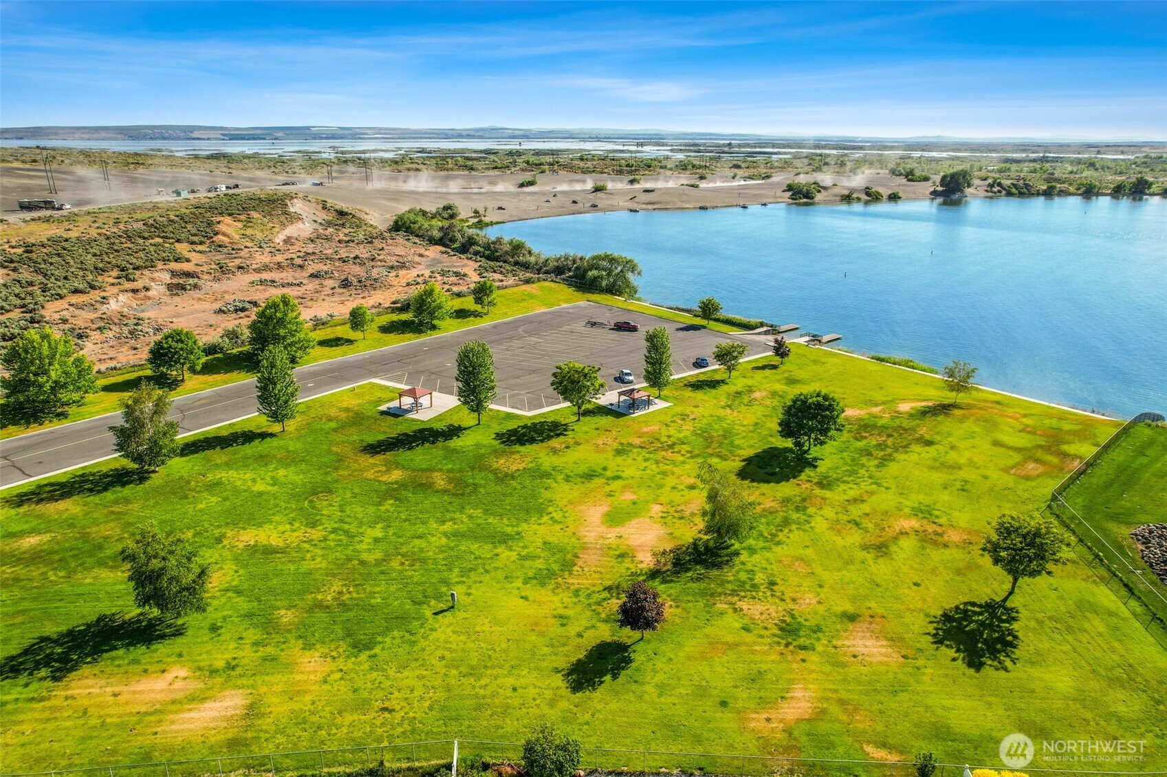 8084 Dune Lake Road Southeast Moses Lake, WA 98837 - Photo 9 of 15 a view of a lake with houses in the background