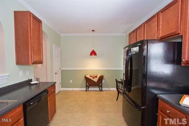 a kitchen with refrigerator and window