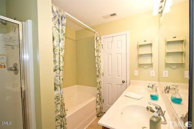 a bathroom with a bathtub and shower