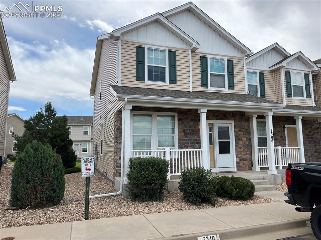 7306 Countryside Grove Fountain, CO 80817 - Photo 2 of 9 a view of a brick house with a yard plants and large tree