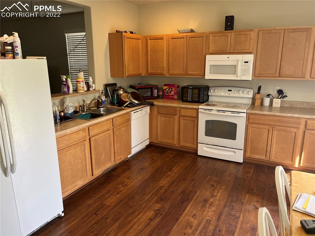 7306 Countryside Grove Fountain, CO 80817 - Photo 6 of 9 a kitchen with a stove a sink and a refrigerator