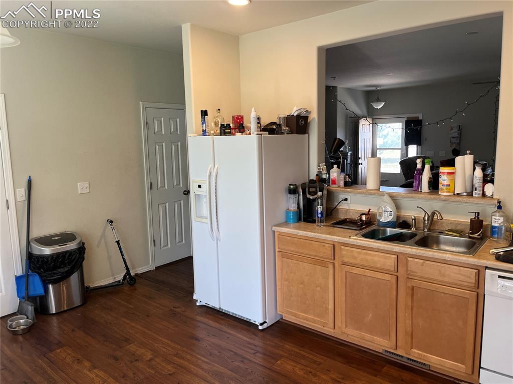 7306 Countryside Grove Fountain, CO 80817 - Photo 7 of 9 a kitchen with a sink and wooden floor